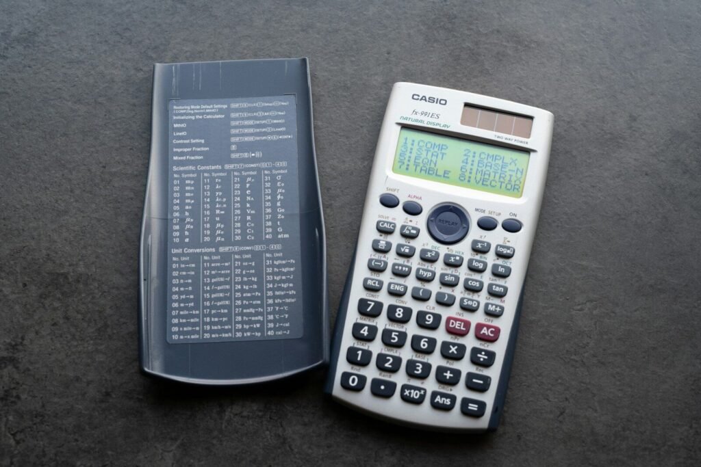 A scientific calculator with its cover open